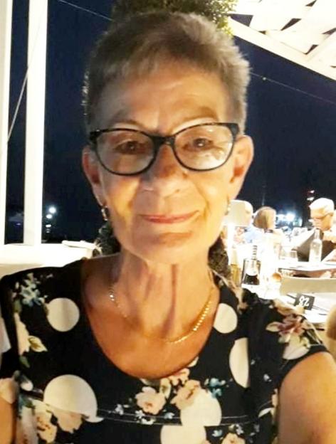 Linda Harris, a woman who survived an attempted murder, wearing a floral and polka-dotted top and glasses.