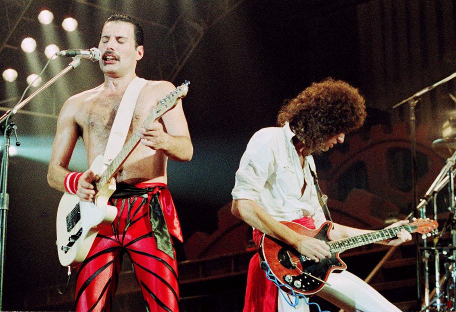 Freddie Mercury and Brian May performing on stage at Wembley Arena.