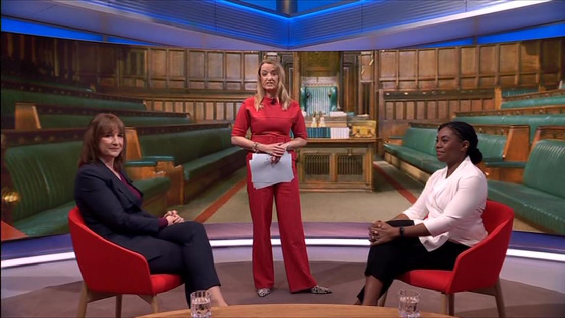 Rachel Reeves, Kemi Badenoch, and Laura Kuenssberg in a studio setting designed to resemble a legislative chamber.