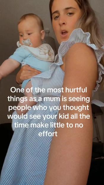 A mother holding her baby while expressing her feelings about people who don't make an effort to see her child.