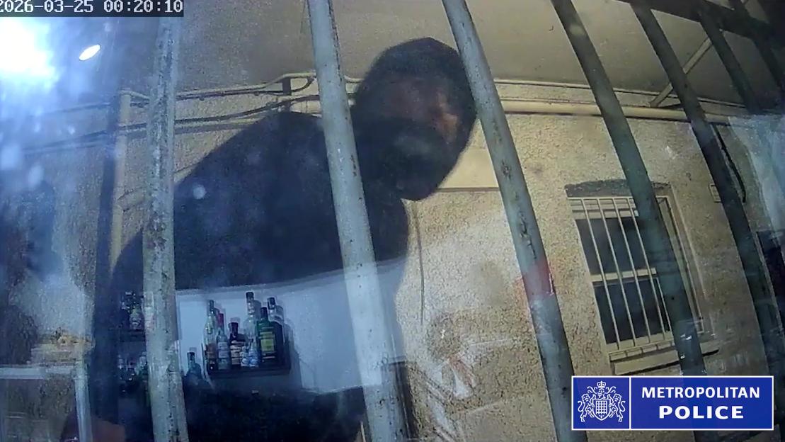 CCTV footage of Anthony Durkan looking through a window, wearing a dark balaclava.