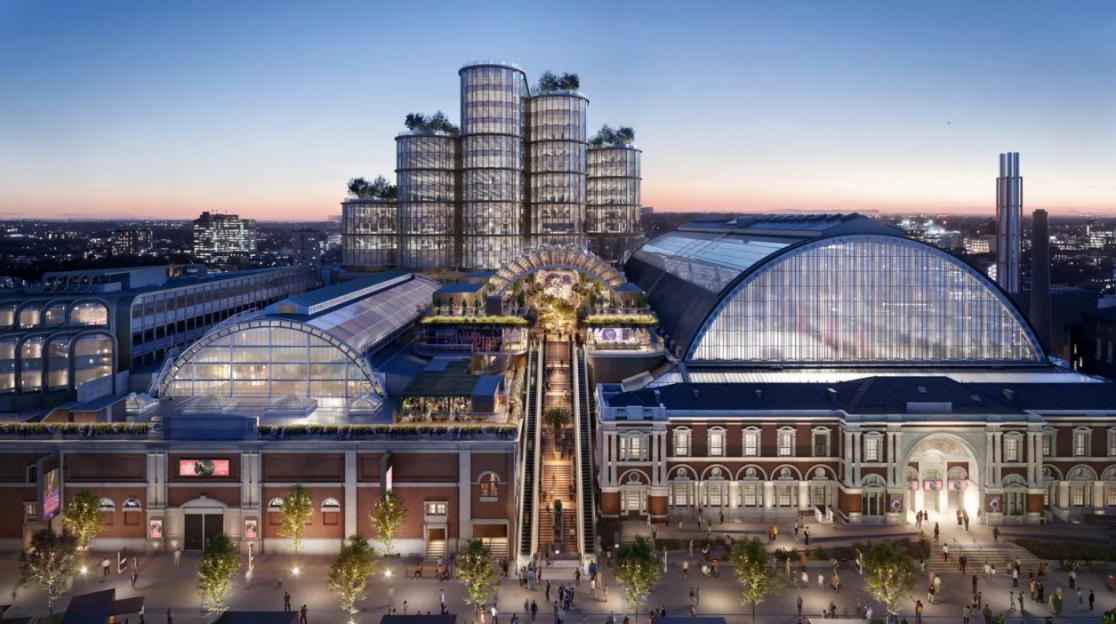 Illustration of a large modern building complex at dusk, featuring a grand staircase and escalators leading up to several cylindrical towers.