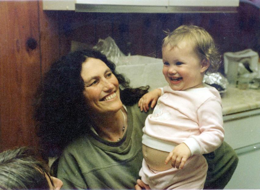 Lin Russell smiling while holding daughter Josie, who is also smiling.