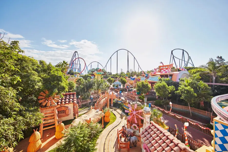 PortAventura World theme park with roller coasters and colorful buildings under a clear sky.