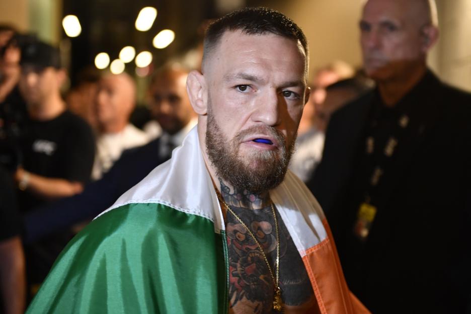 Conor McGregor preparing to fight, draped in an Irish flag.