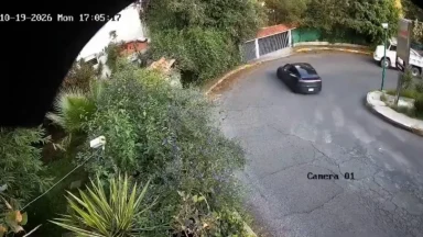 Terrifying moment speeding Tesla flies off ledge and plummets to ground after smashing through wall