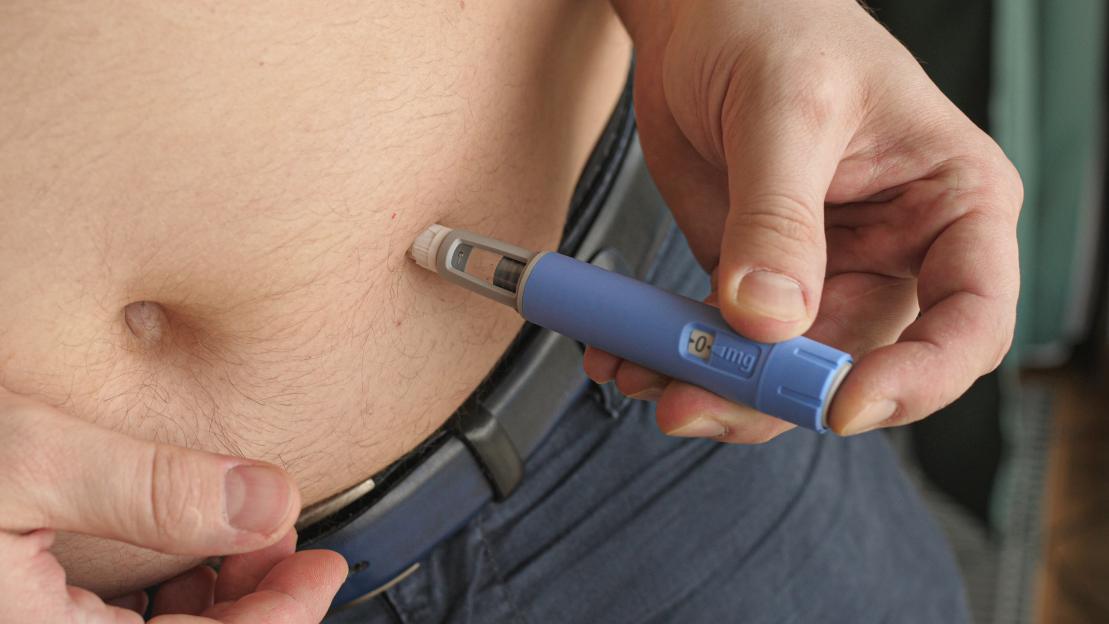 A person injecting semaglutide into their abdomen for diabetes management.