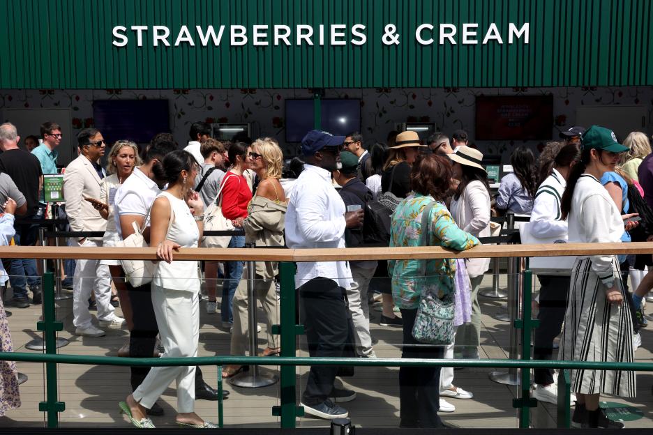 Spectators queue for strawberries and cream at Wimbledon.