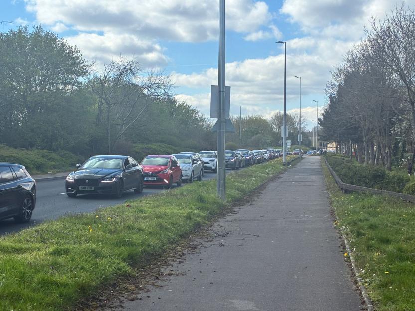 Cars lined up on the road leading to Costco in Erdington before the Bank Holiday Easter.