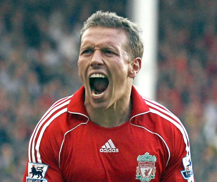 Footballer Craig Bellamy in a red Liverpool jersey, shouting with his mouth open.