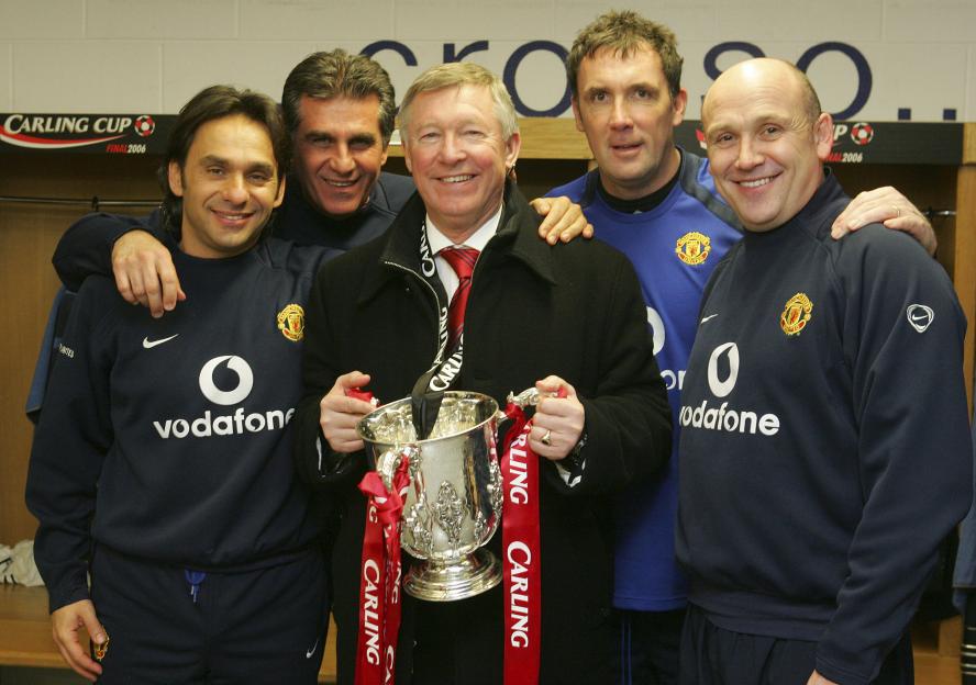 Five men in a locker room, Valter di Salvo, Carlos Queiroz, Sir Alex Ferguson, Tony Coton and Mike Phelan, celebrate winning the 2006 League Cup.