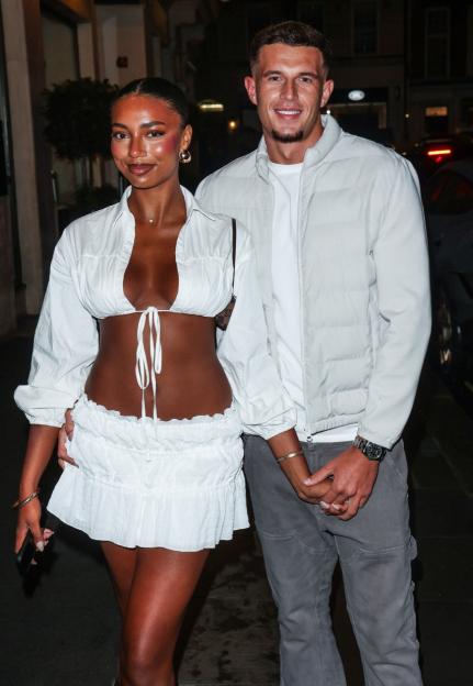 Uma Jammeh and Wil Anderson holding hands in London.