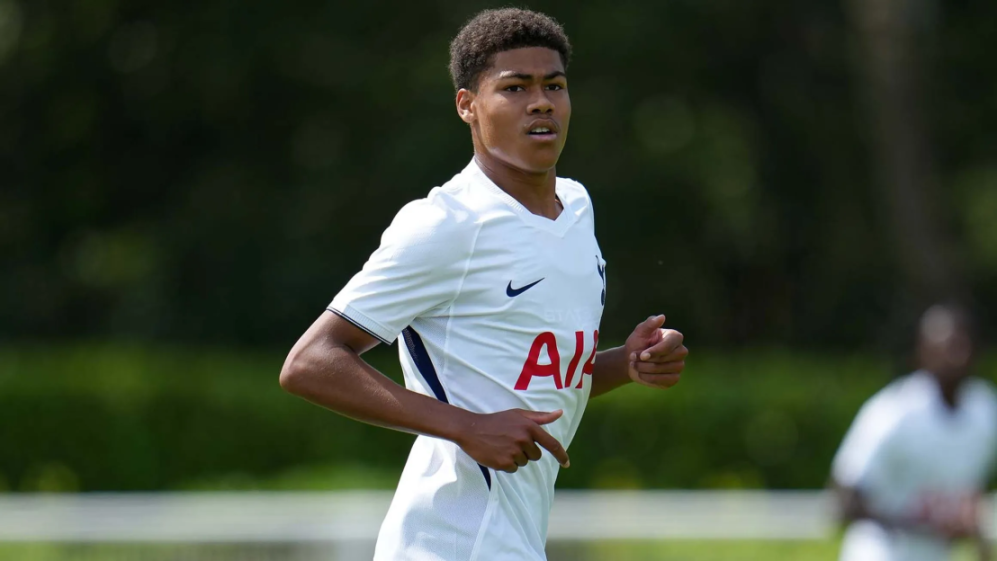 Footballer wearing a white Tottenham Hotspur jersey.