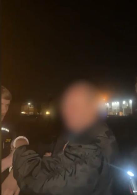 Clive Harris being arrested by police following the attack.