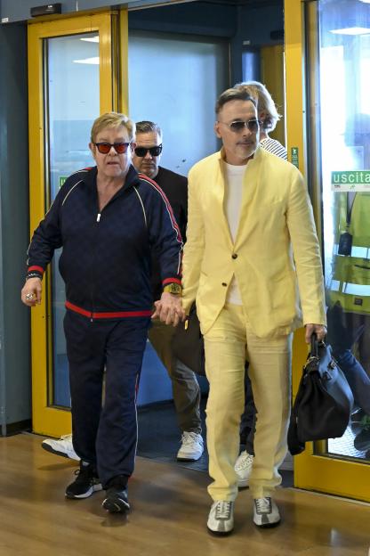 Elton John and David Furnish depart a wedding.