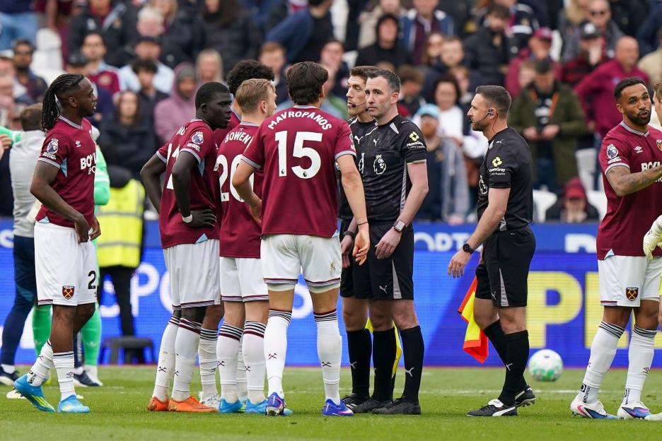 West Ham United forward Jarrod Bowen (20) and West Ham United defender Konstantinos Mavropanos (15) speak with Referee Chris Kavanagh after the West Ham United v Arsenal Premier League match at the London Stadium, London, England on 10 May 2026