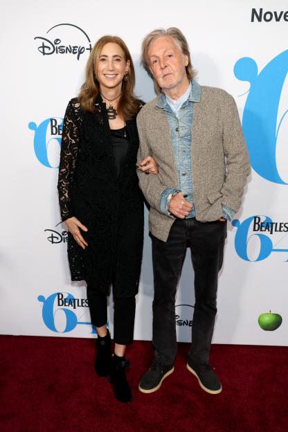 Nancy Shevell and Paul McCartney pose at the Beatles '64 Premiere.