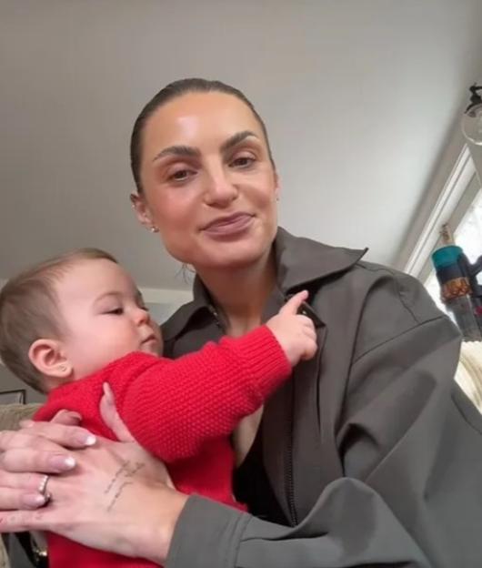 Domenica Calarco holding a baby in a red sweater, with text that reads "I don't know how to co-parent".