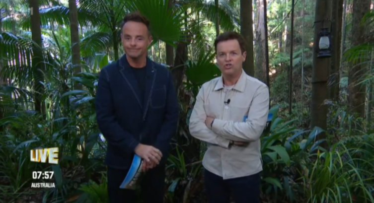 Two men in a jungle environment, with a "LIVE" overlay on the bottom left.