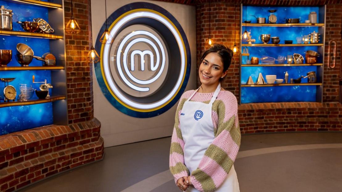 Television personality Shakira Khan wearing a MasterChef apron in the MasterChef kitchen.