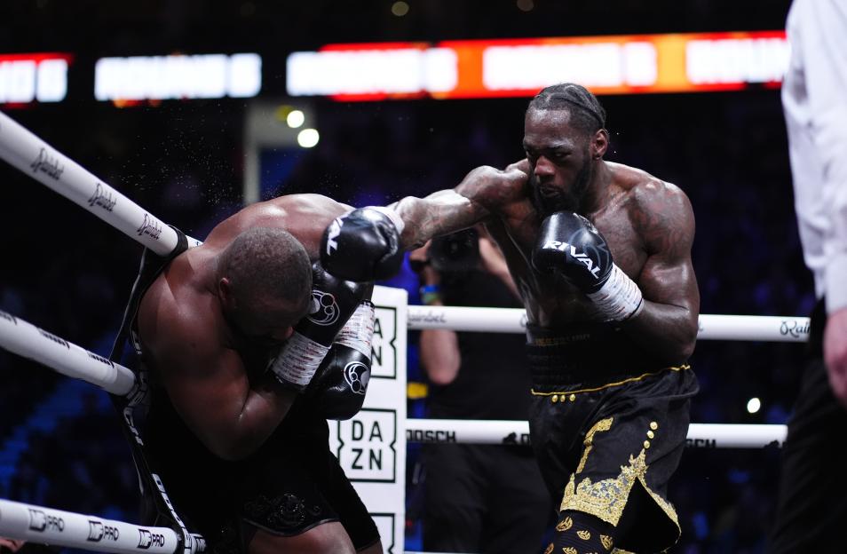 Deontay Wilder punching Derek Chisora in a boxing match.