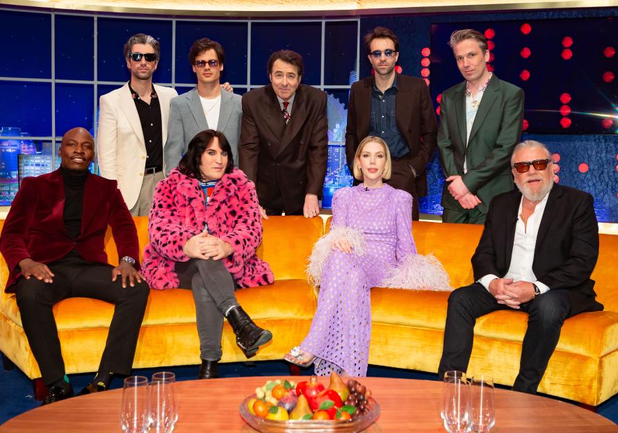 Jonathan Ross, Eddie Kadi, Noel Fielding, Katherine Ryan, Ray Winstone, and The Vaccines pose on the set of 'The Jonathan Ross Show'.
