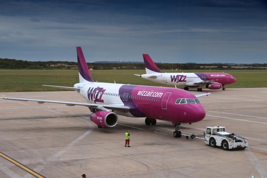 Two Wizz Air Airbus A320 commercial airplanes on the tarmac at Doncaster Sheffield Airport.