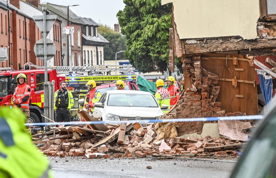 Emergency services rush to street after bin lorry smashes through side of house