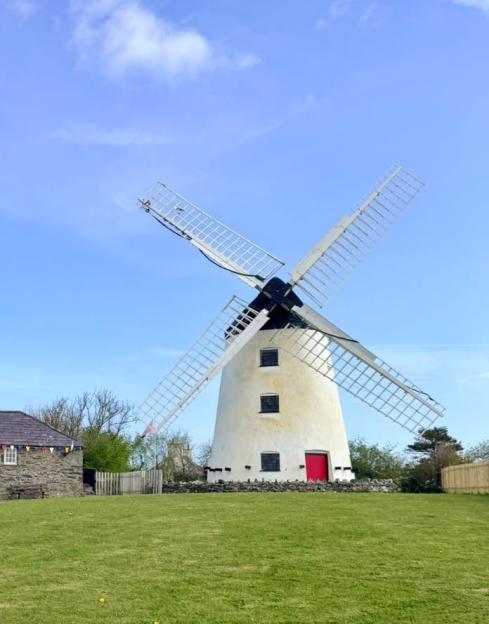Windmill row erupts as owner ordered to repaint it after colourful makeover