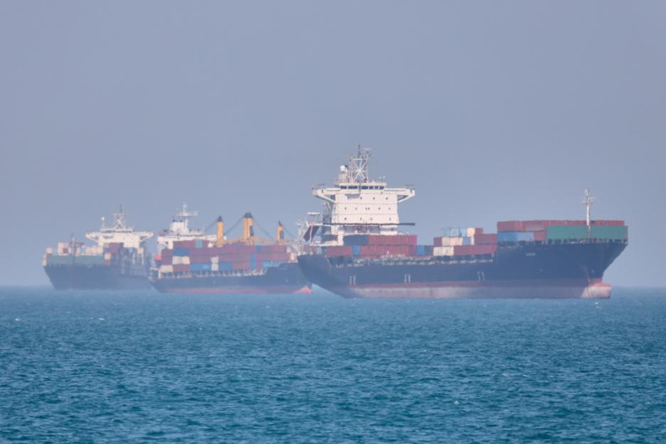 Three container ships at anchor in the Strait of Hormuz.