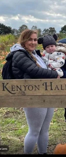 Jess-Hulley Jones carrying her son Theodore at a pumpkin patch.