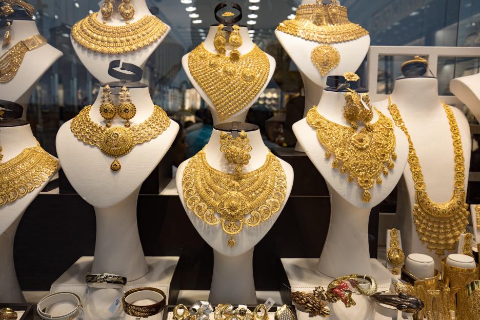 Gold necklaces and earrings displayed in a shop window at the Gold Souk in Dubai.