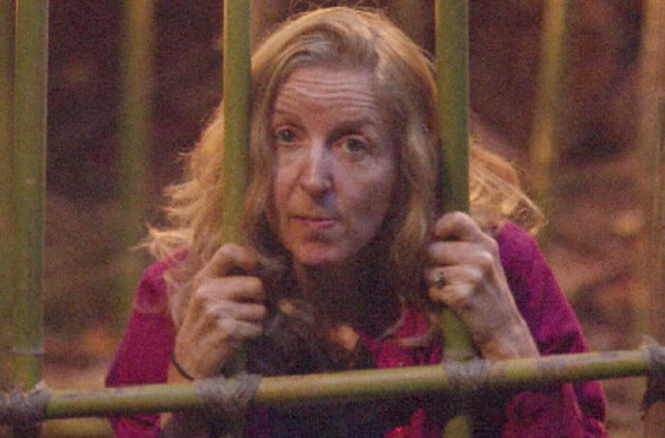 Gillian McKeith looking through bamboo bars.