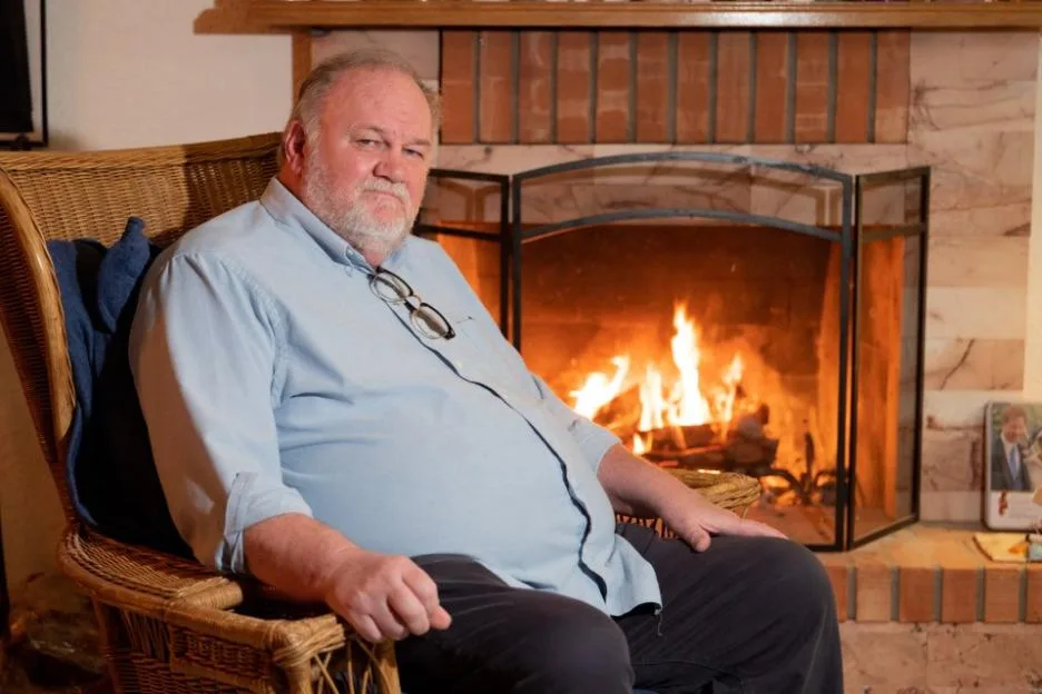 Thomas Markle sitting in a wicker chair inside his home in Mexico, with a fireplace in the background.