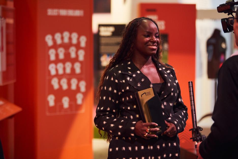 Eniola Aluko holding an award from the National Football Museum Hall of Fame.