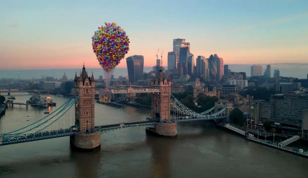 Illustration of a colorful bunch of balloons with a house attached floating over the Tower Bridge in London.