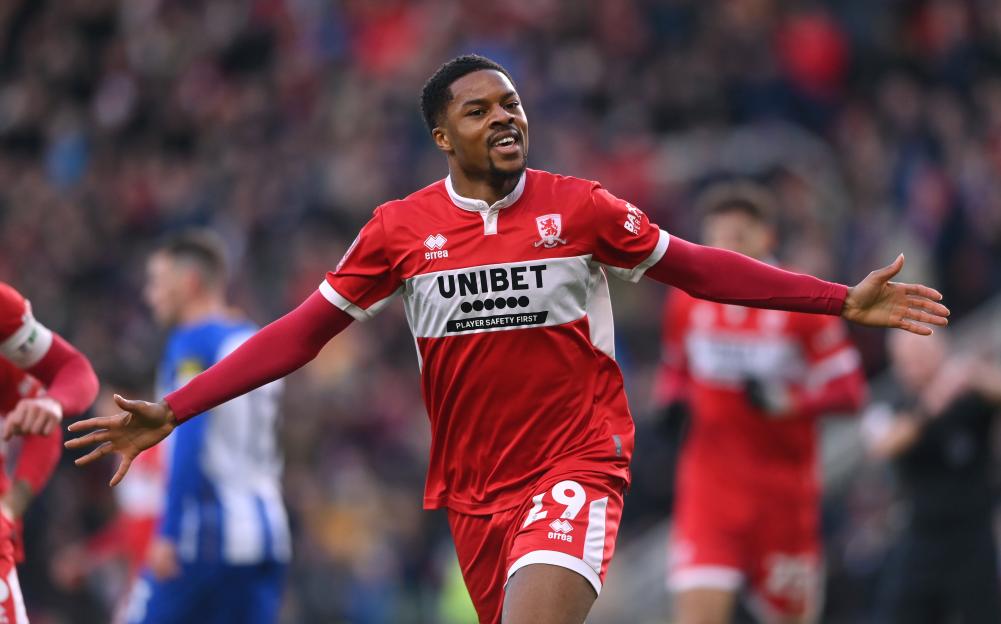 Middlesbrough striker Chuba Akpom celebrates his goal with arms outstretched.