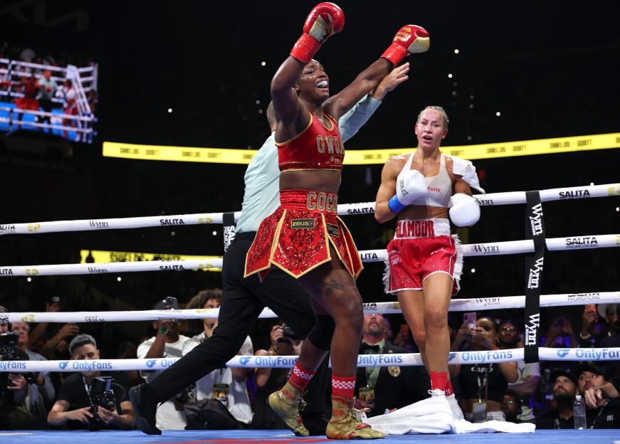 Claressa Shields celebrates her victory over Kaye Scott in the boxing ring.
