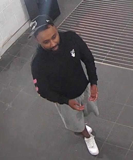 Image of a man in a black baseball cap and black hoodie.