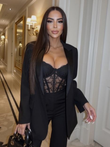 Woman in a black suit with a black lace bustier.