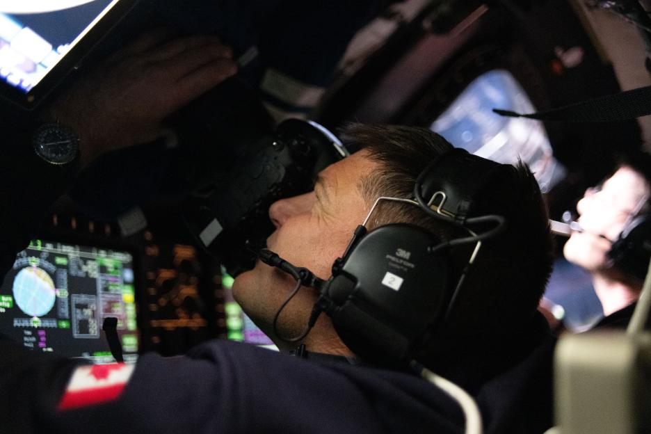 Canadian Space Agency astronaut Jeremy Hansen taking images of the Moon through the Orion spacecraft window.