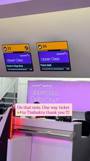 An airport check-in area with "Upper Class Check-in Bag Drop" and "Upper Class Ticket Desk" signs for Virgin Atlantic and Delta, with a pink banner saying "On that note. One way ticket to Timbuktu thank you!!!!"