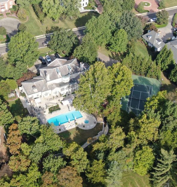 Aerial view of Nicole Kidman and Keith Urban's Nashville home, featuring a large house, swimming pool, tennis court, and a dome-shaped sound bath installation.