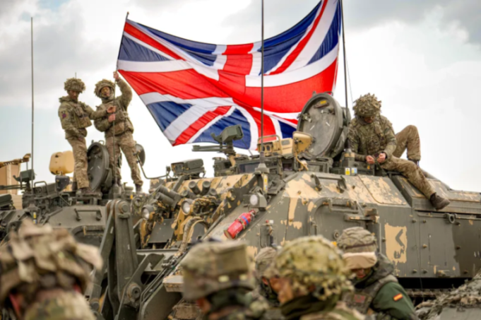 British soldiers with a UK flag on military vehicles.