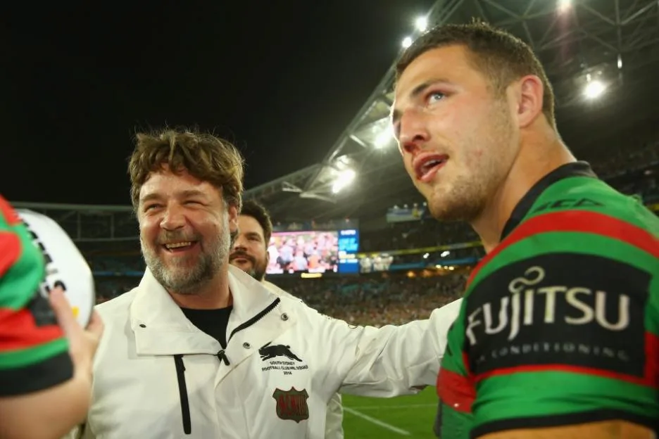a man wearing a fujitsu shirt talks to another man