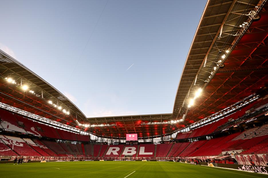General view of the Red Bull Arena featuring red seats and the letters "RBL" in white against the red background, before the match between RB Leipzig and Bayer 04 Leverkusen.