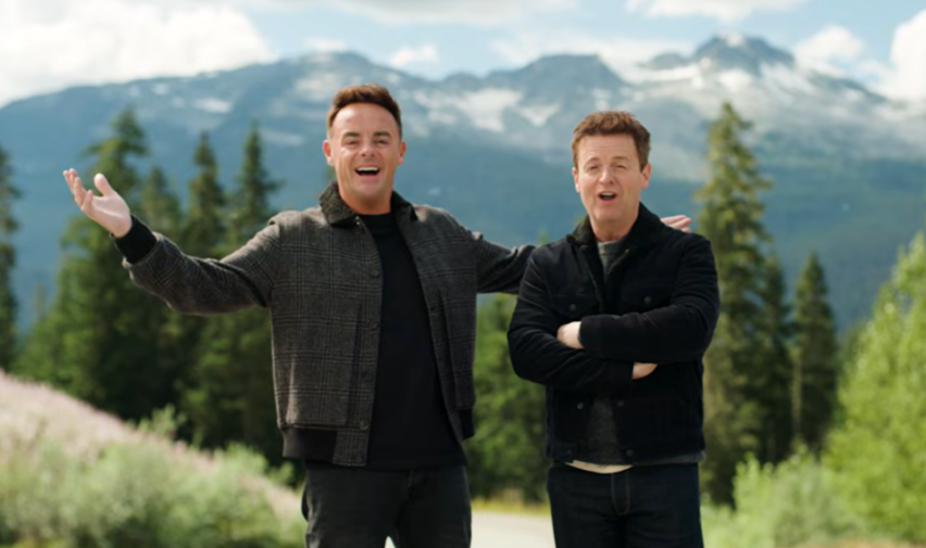 Ant and Dec smiling outdoors with mountains in the background.