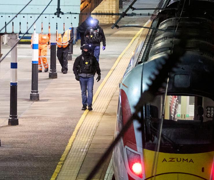 Police and transport personnel at Huntingdon Station investigating a train attack.