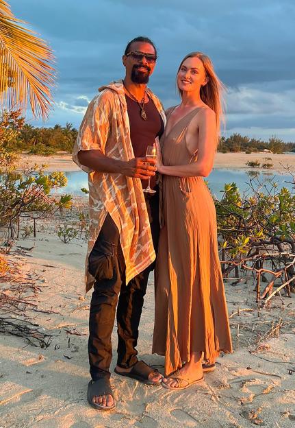 David Haye and Sian Osborne pose on a beach with a drink.