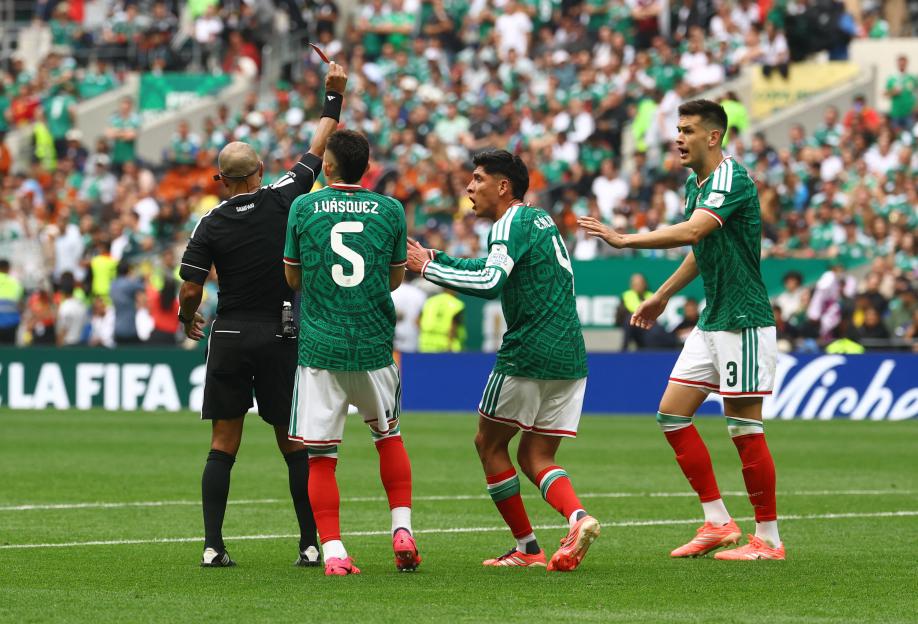 Referee Wilton Sampaio shows a red card to Mexico's Cesar Montes as Mexico's Johan Vasquez and Edson Alvarez protest during the FIFA World Cup 2026 match against South Africa.
